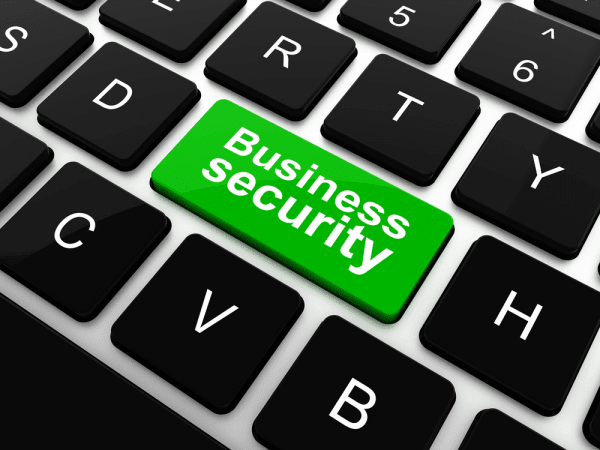 Keyboard with green key labeled business security representing business IT management